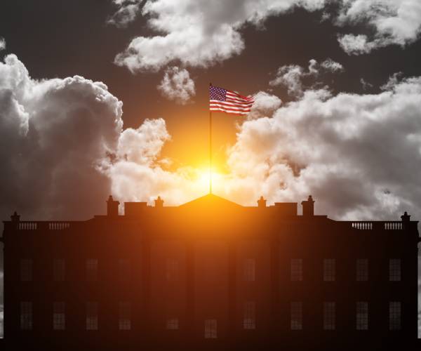 white house with sun coming from behind clouds