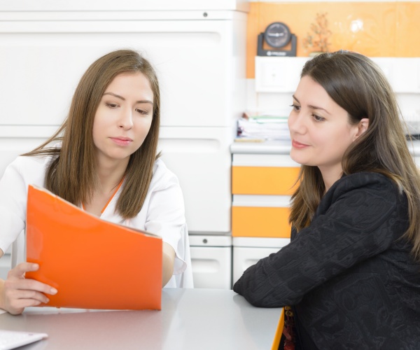 Doctor talking to young woman about her health