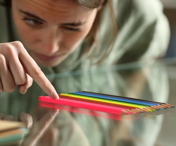person obsessively lining up pencils