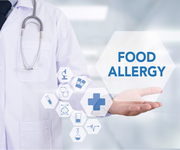 physician holding hand out with 'food allergy'