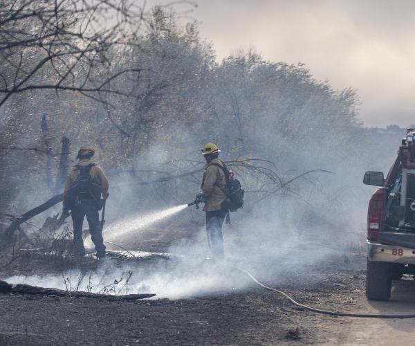 firemen putting water on fires in Los Angeles