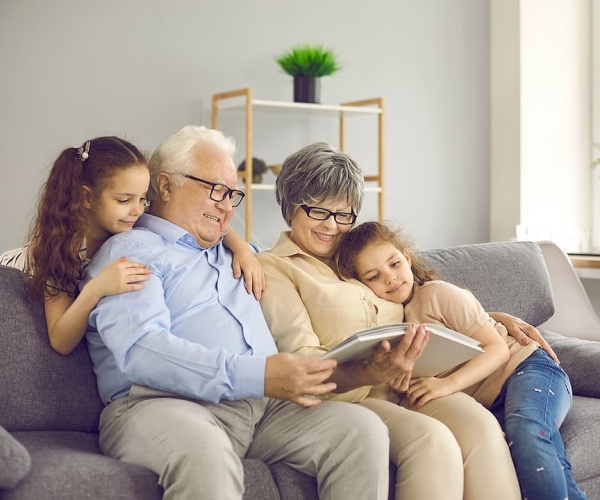 grandparents on couch with grandchildren