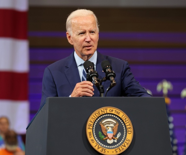 joe biden speaks into a microphone