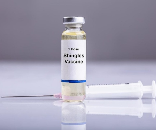 vial of shingles vaccine, syringe