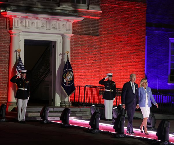 president joe biden and first lady jill biden walking before thursday's speech