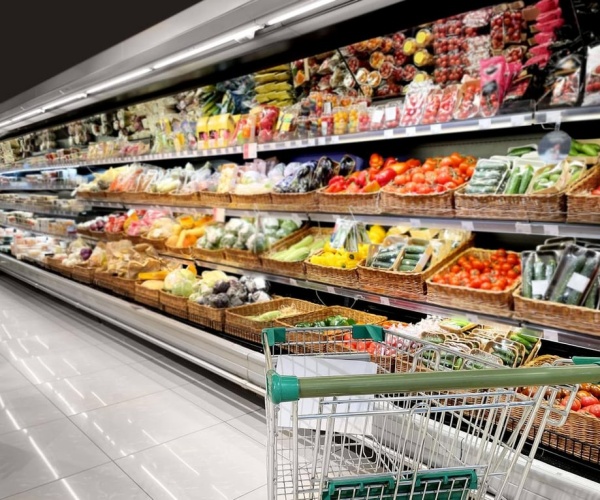 produce aisle in grocery store, some packed in plastic