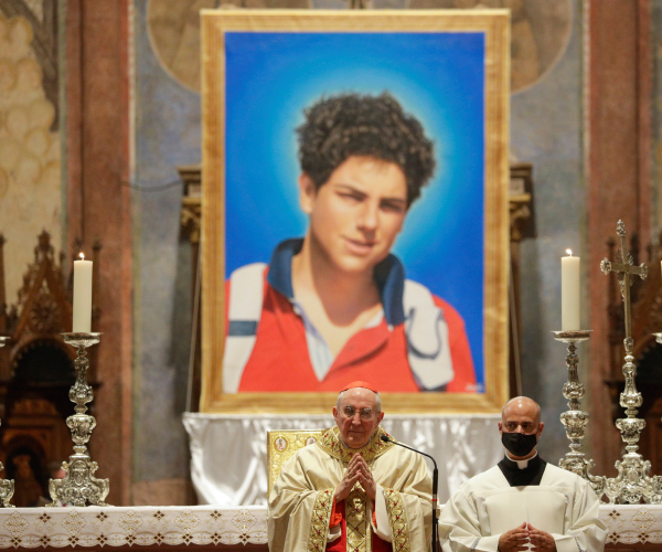 a ceremony in an ornate church with a large photo of the teen in the background