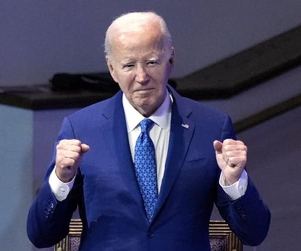 president joe biden gestures with his fists