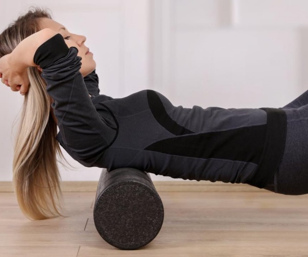 woman doing a strength exercise on a bolster