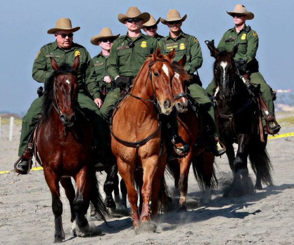 border patrol agents ride horses