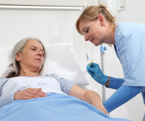 doctor talking to patient in hospital bed