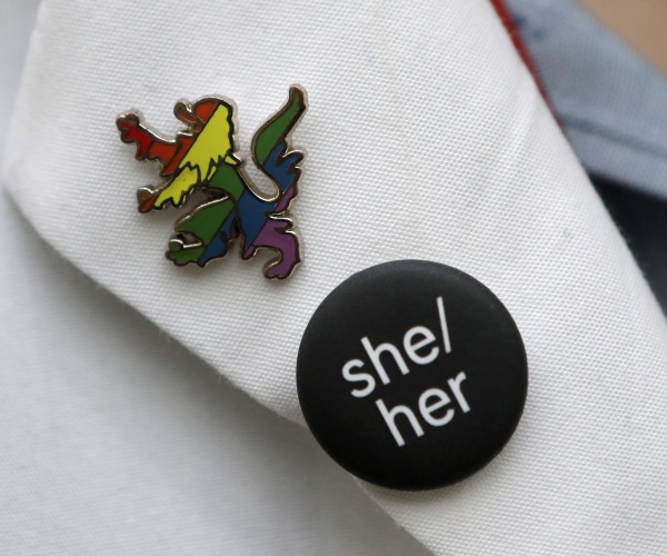 pronouns pinned on a lapel 