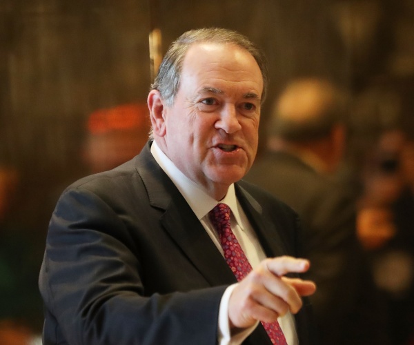 huckabee in a suit and red patterned tie