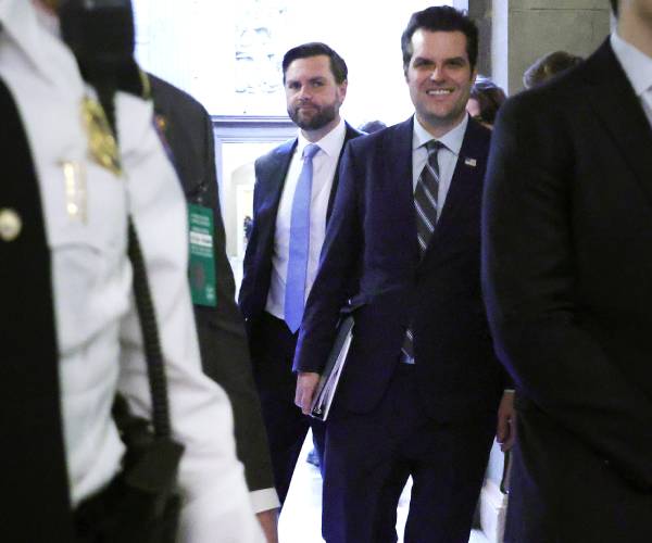 gates and vance walking between people in a hallway