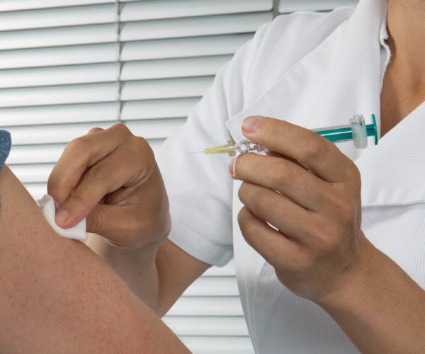 a person receives a covid injection