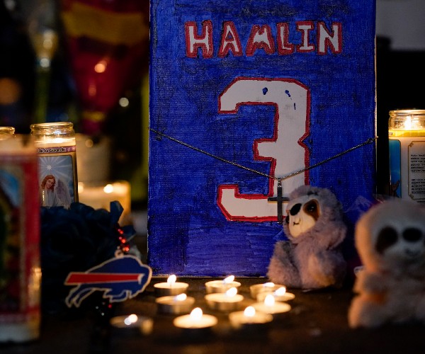 candles stuffed animals and a painting of hamlins jersey with a cross necklace