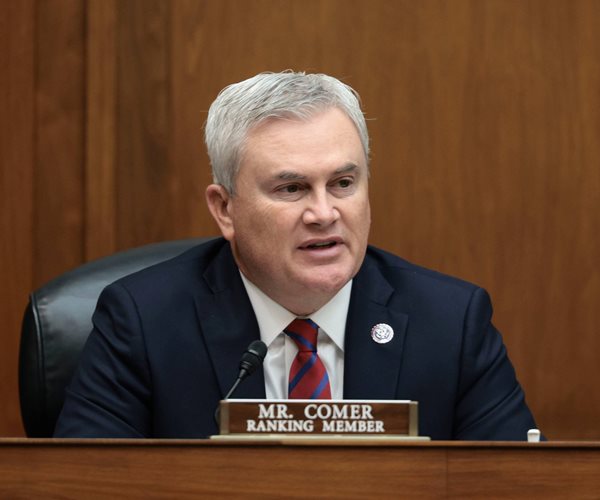 James Comer sits at a desk behind his nameplate