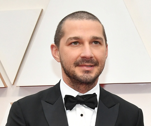 shia labeouf stands on red carpet