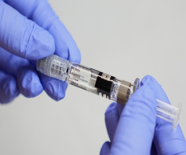 syringe with flu vaccine