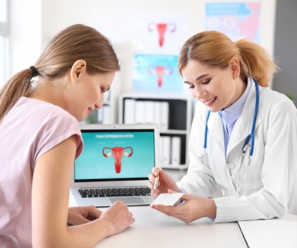 a woman discussing her health with her doctor