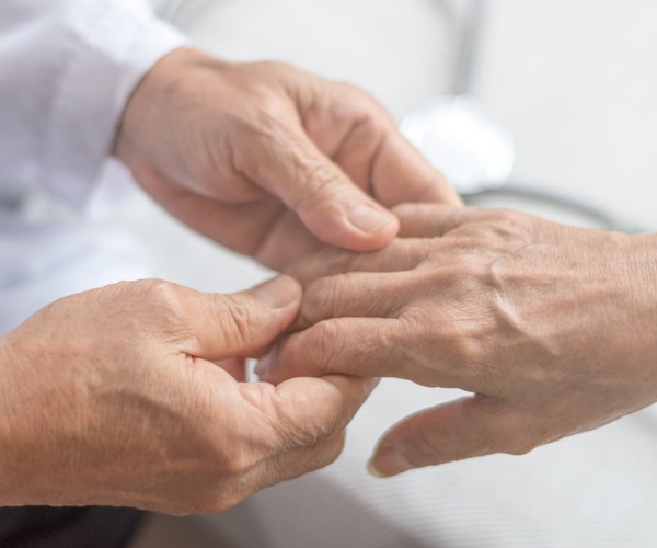 person holding an older person's hands