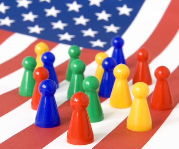 various colored game pieces shaped like people on an american flag