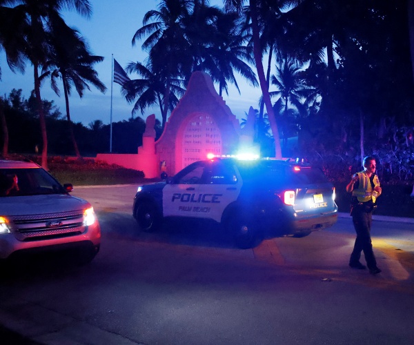 police direct traffic outside an entrance to mar-a-lago