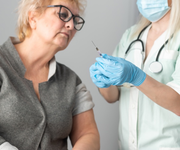 older woman getting her flu shot