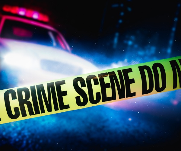 police car at a crime scene with police tape, high contrast image