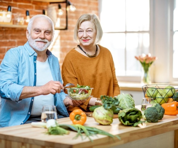 older couple prepares vegetarian meal