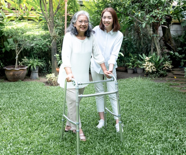 daughter helping mother with her walker