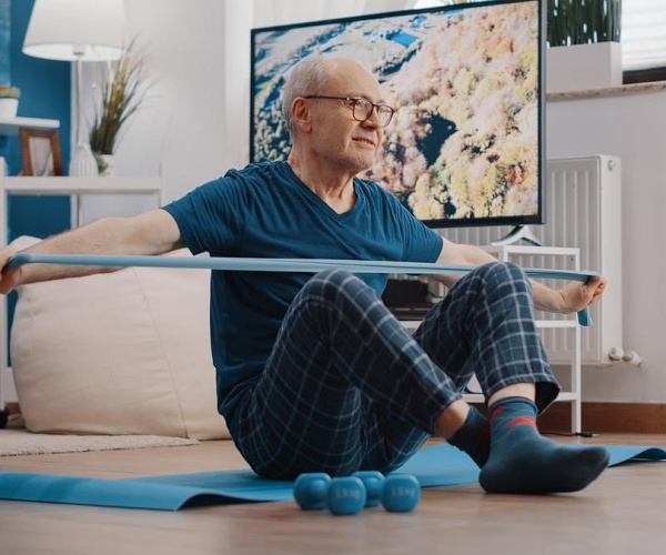 man doing physical therapy exercises at home