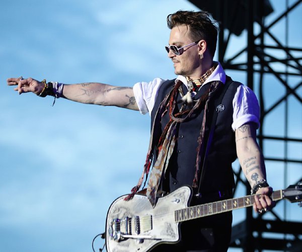 johnny depp performs at a concert