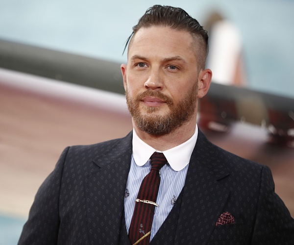 tom hardy stands on red carpet