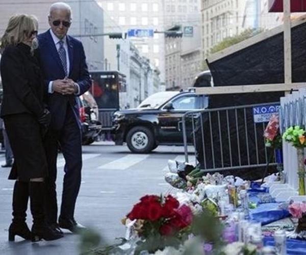 joe biden and first lady jill biden lay flowers at a memorial