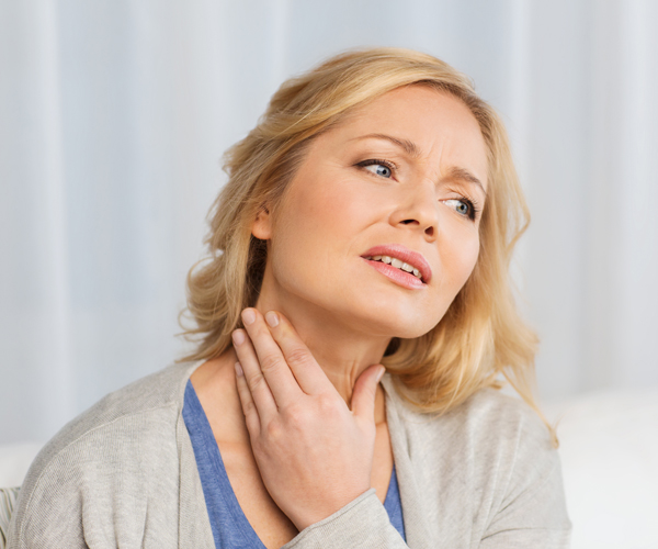 a woman experiencing neck pain