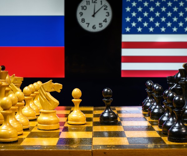 a chess board with american and russian flags in the background