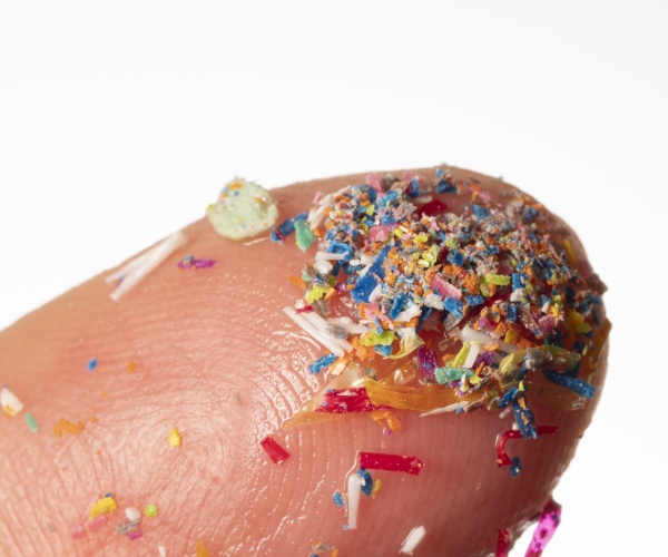 close-up of microplastics on a person's finger