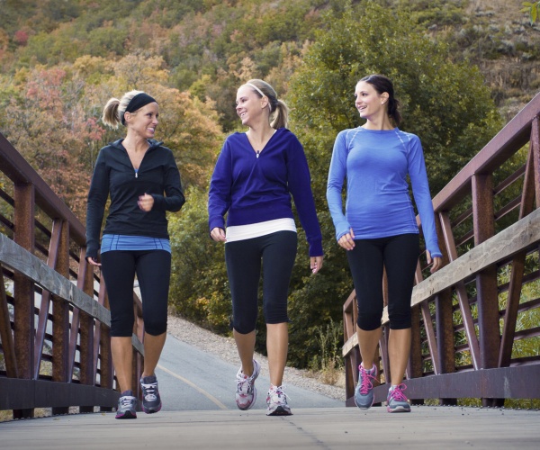 three women walking for fitness outside