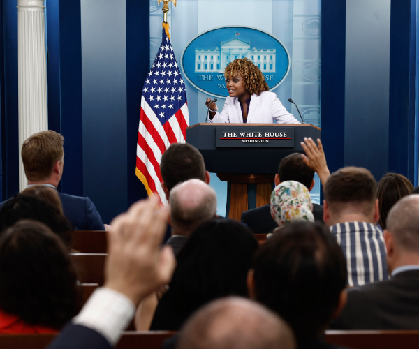 jean pierre speaking to the press which is assembled in front of her