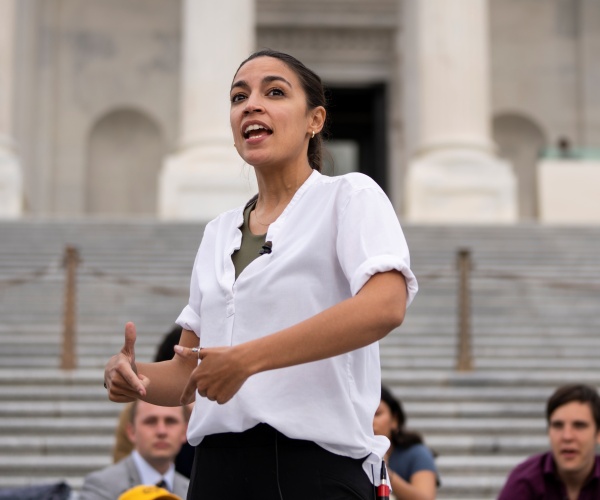 alexandria ocasio-cortez speaks to a reporter