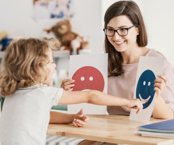 teacher showing cards with illustrations to child