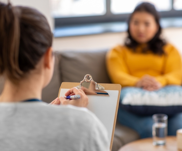 a woman psychologist and patient at a psychotherapy session