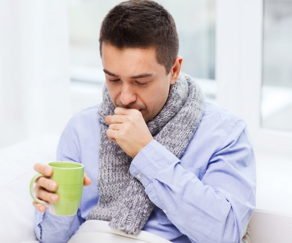 a sick man coughing