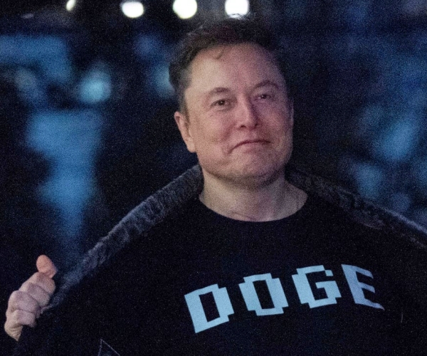 elon musk showing off his doge shirt