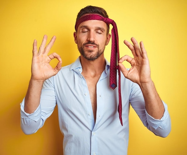 man with tie around head looking drunk