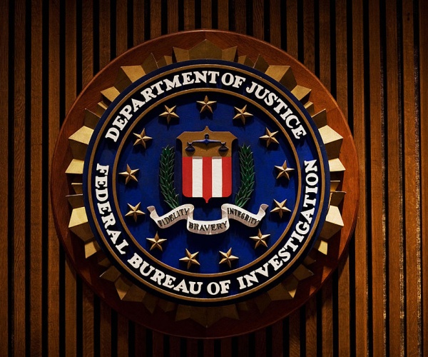 crest of the federal bureau of investigation with brown wood background