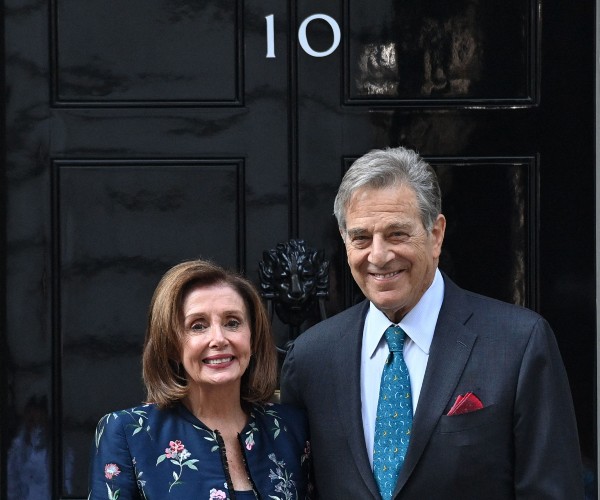 nancy and paul pelosi pose for media
