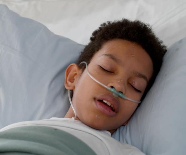 young boy with supplemental oxygen in hospital