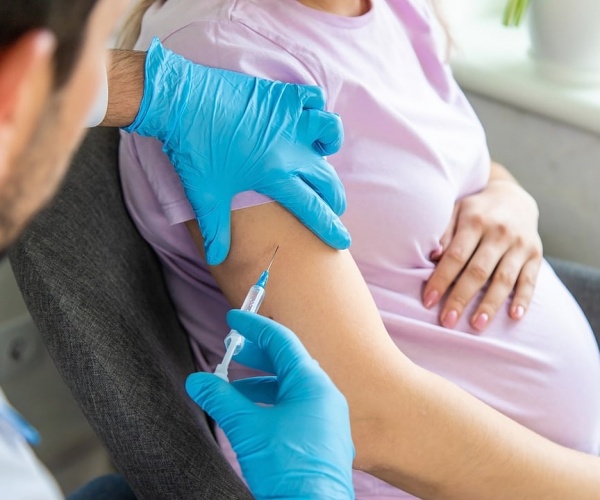 pregnant woman getting a COVID vaccine